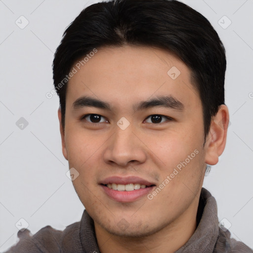 Joyful asian young-adult male with short  brown hair and brown eyes