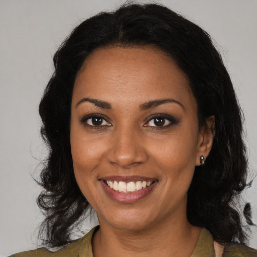 Joyful black young-adult female with medium  brown hair and brown eyes