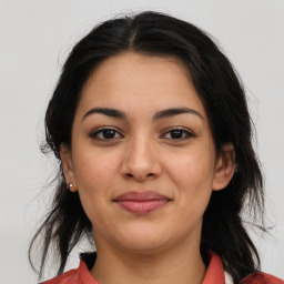 Joyful latino young-adult female with medium  brown hair and brown eyes