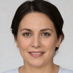 Joyful white adult female with medium  brown hair and brown eyes