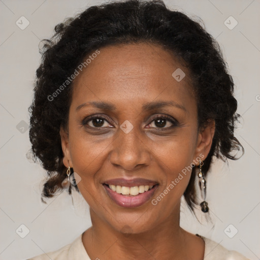 Joyful black adult female with medium  brown hair and brown eyes