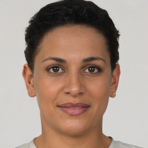 Joyful latino young-adult female with short  brown hair and brown eyes