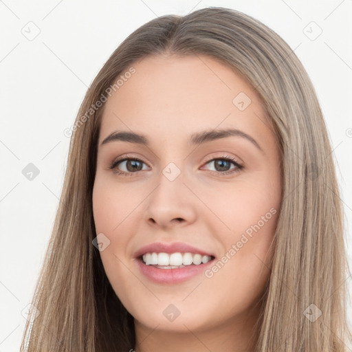 Joyful white young-adult female with long  brown hair and brown eyes