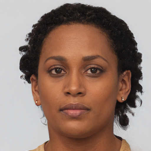 Neutral black young-adult female with short  brown hair and brown eyes