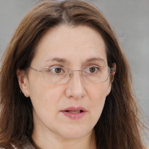 Joyful white adult female with long  brown hair and brown eyes