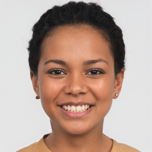 Joyful latino young-adult female with short  brown hair and brown eyes