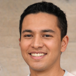 Joyful white young-adult male with short  black hair and brown eyes