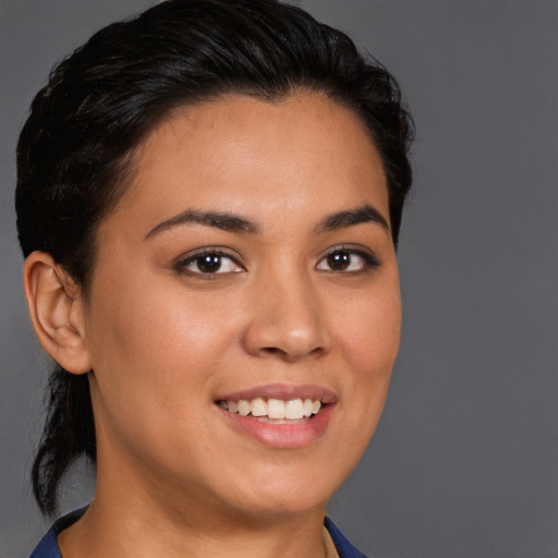 Joyful latino young-adult female with short  brown hair and brown eyes