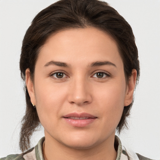 Joyful white young-adult female with medium  brown hair and brown eyes