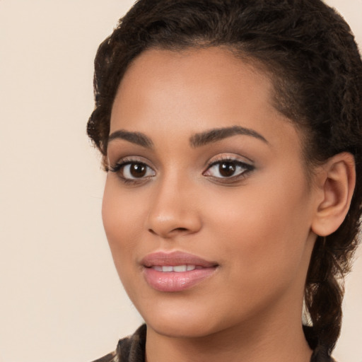 Joyful latino young-adult female with long  brown hair and brown eyes