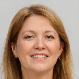 Joyful white adult female with long  brown hair and grey eyes