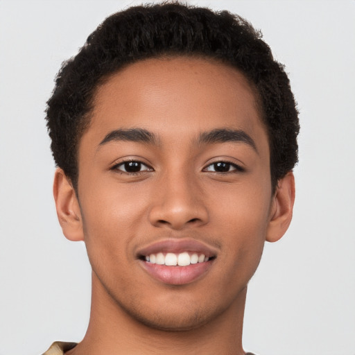 Joyful latino young-adult male with short  brown hair and brown eyes