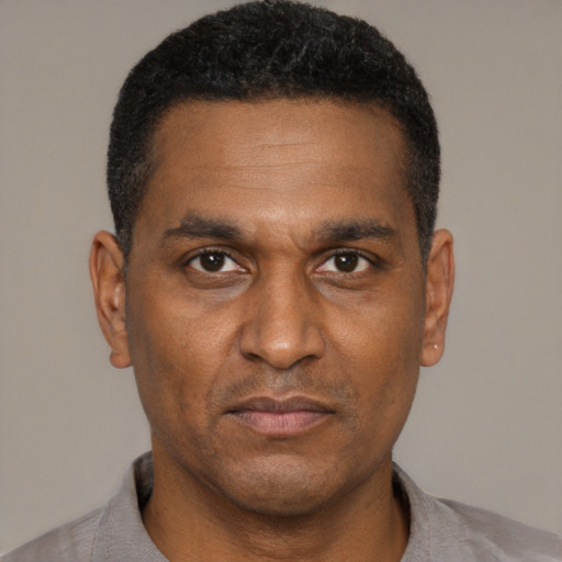 Neutral black adult male with short  black hair and brown eyes