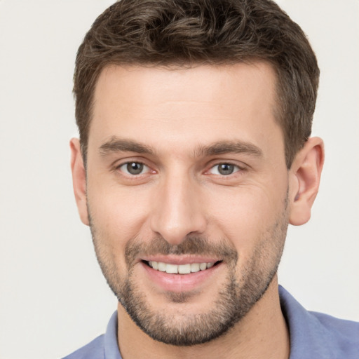 Joyful white young-adult male with short  brown hair and brown eyes