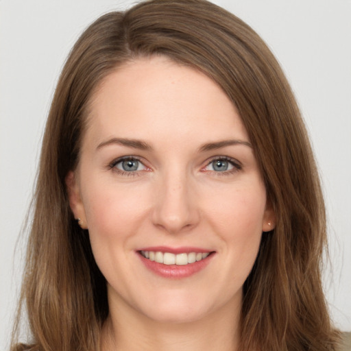 Joyful white young-adult female with long  brown hair and grey eyes