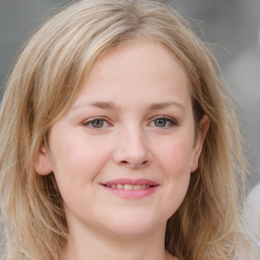 Joyful white young-adult female with long  brown hair and blue eyes