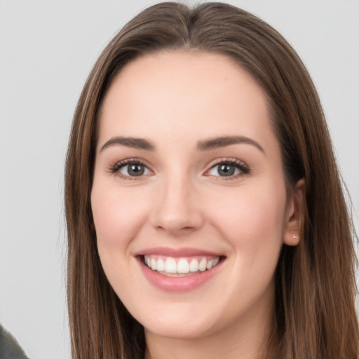 Joyful white young-adult female with long  brown hair and grey eyes