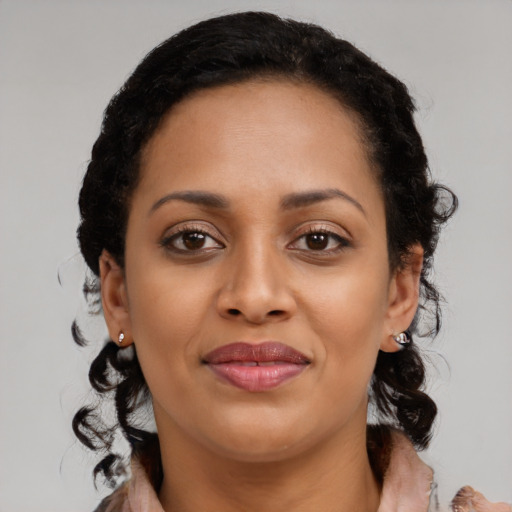 Joyful black young-adult female with medium  black hair and brown eyes