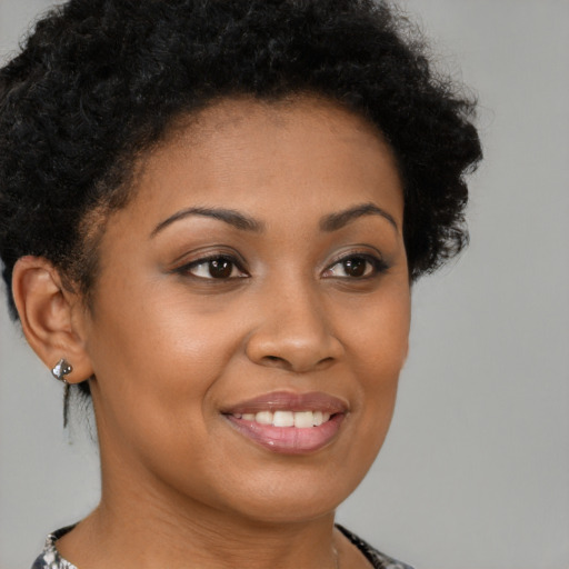 Joyful black young-adult female with short  brown hair and brown eyes
