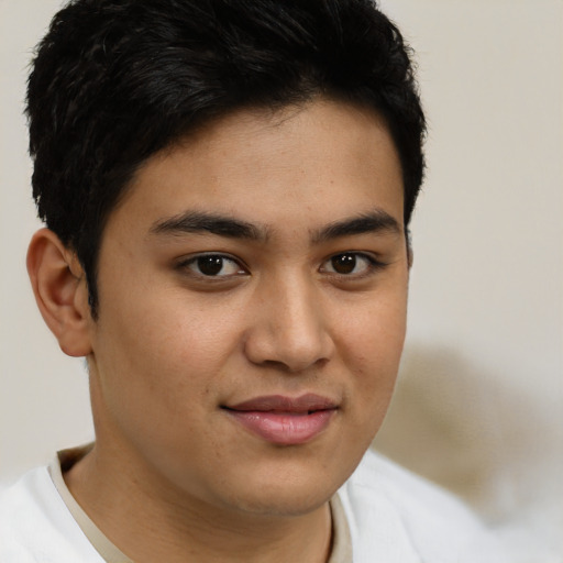 Joyful latino young-adult male with short  brown hair and brown eyes