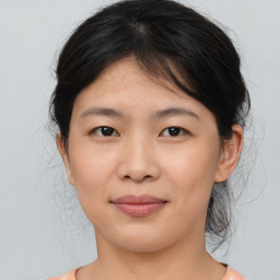 Joyful asian young-adult female with medium  brown hair and brown eyes