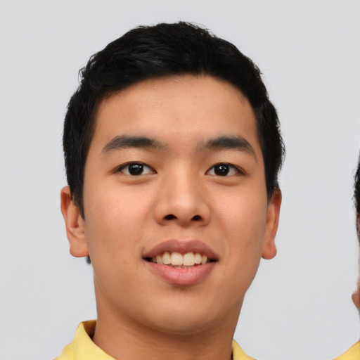 Joyful asian young-adult male with short  brown hair and brown eyes