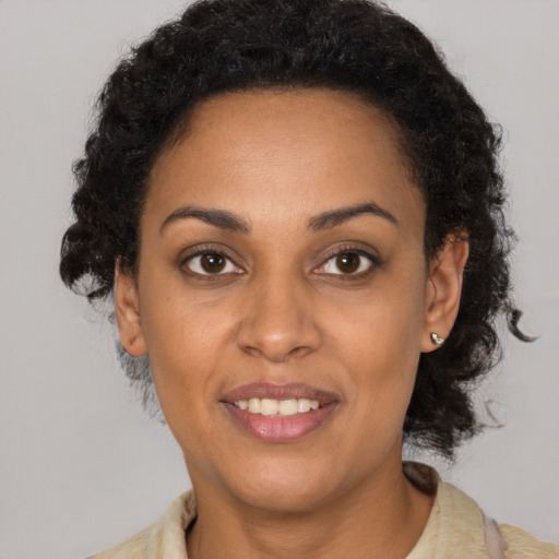 Joyful black young-adult female with medium  black hair and brown eyes