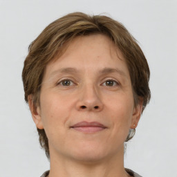 Joyful white adult female with short  brown hair and brown eyes