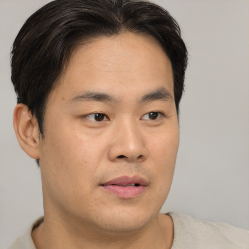 Neutral asian young-adult male with short  brown hair and brown eyes