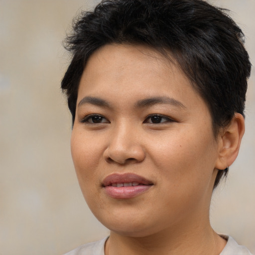 Joyful asian young-adult female with short  brown hair and brown eyes