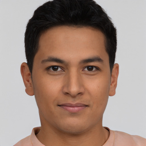 Joyful latino young-adult male with short  brown hair and brown eyes
