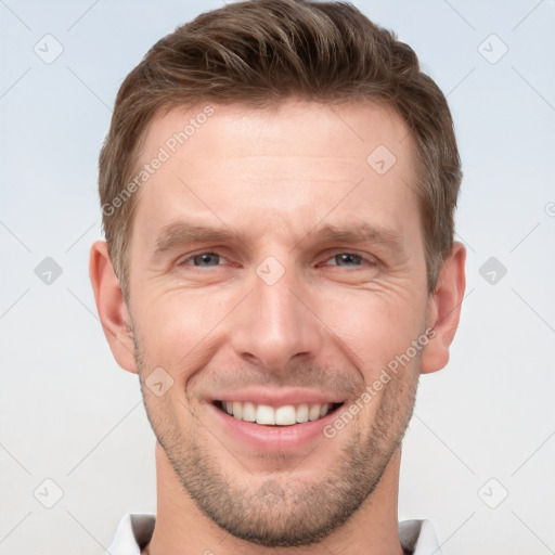 Joyful white young-adult male with short  brown hair and grey eyes