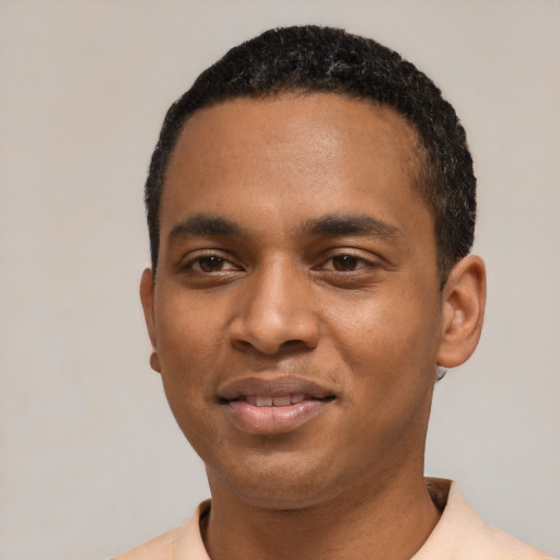 Joyful black young-adult male with short  black hair and brown eyes