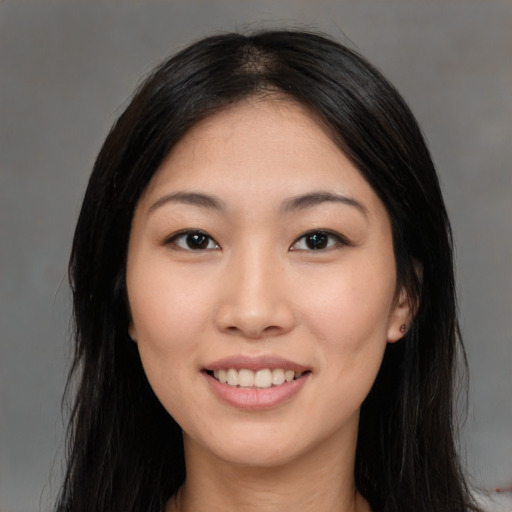 Joyful asian young-adult female with long  brown hair and brown eyes