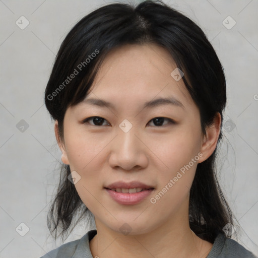 Joyful asian young-adult female with medium  black hair and brown eyes