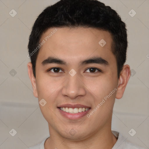 Joyful latino young-adult male with short  brown hair and brown eyes