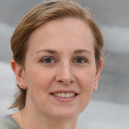 Joyful white adult female with short  brown hair and grey eyes