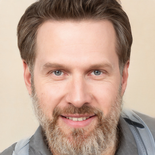 Joyful white adult male with short  brown hair and grey eyes