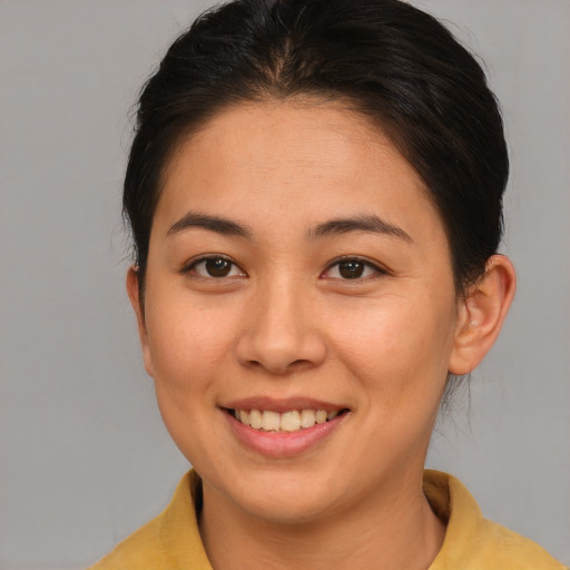Joyful asian young-adult female with medium  brown hair and brown eyes