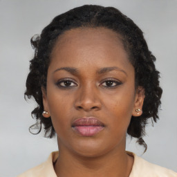 Neutral black young-adult female with medium  brown hair and brown eyes