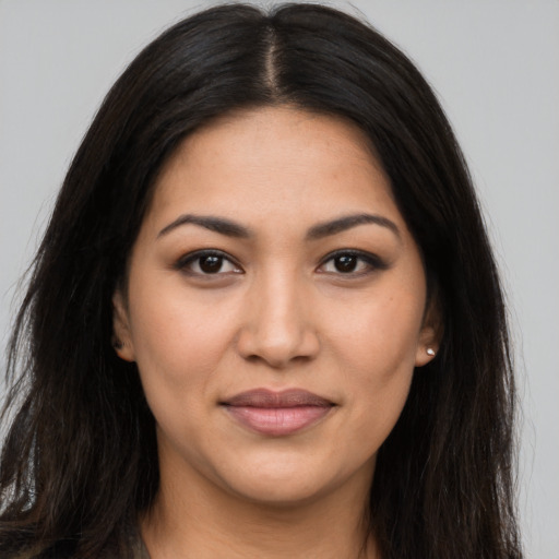 Joyful latino young-adult female with long  brown hair and brown eyes