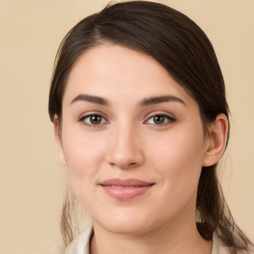 Joyful white young-adult female with long  brown hair and brown eyes