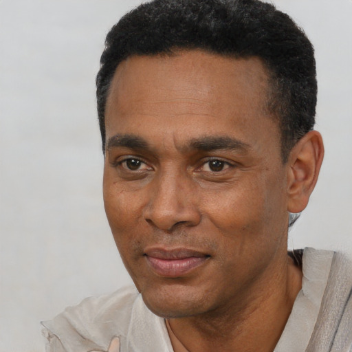 Joyful black adult male with short  black hair and brown eyes