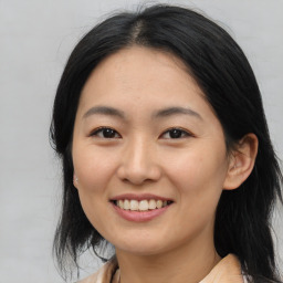 Joyful asian young-adult female with medium  black hair and brown eyes