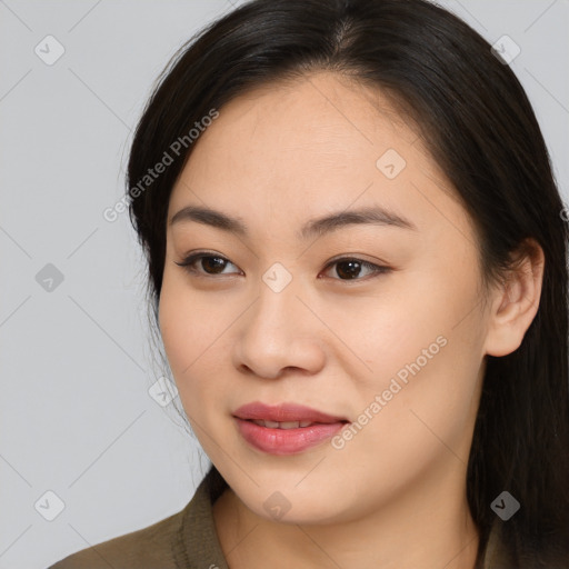 Joyful asian young-adult female with long  brown hair and brown eyes