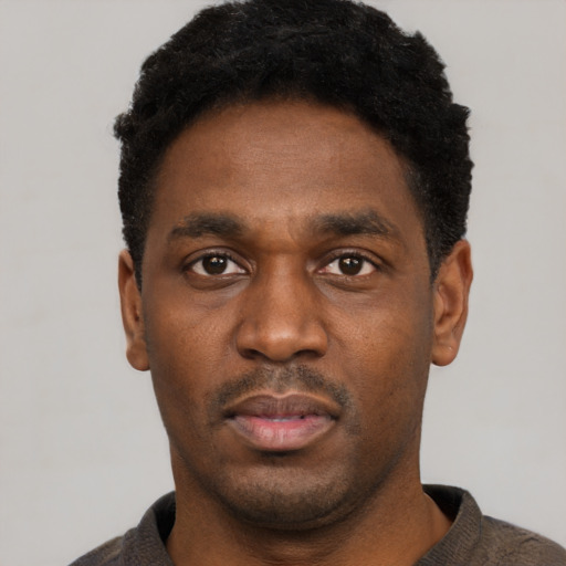 Neutral black young-adult male with short  black hair and brown eyes