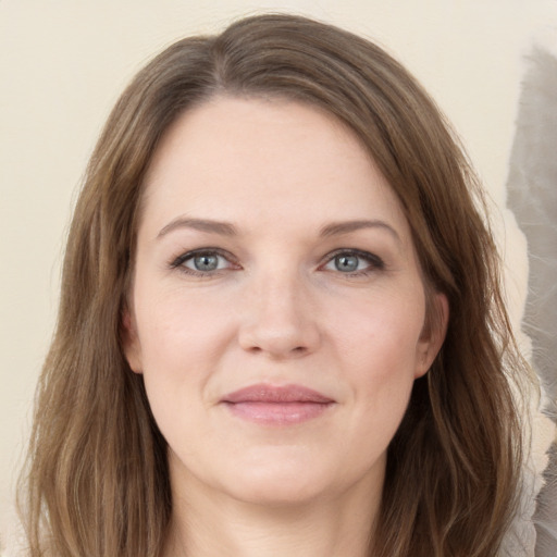 Joyful white young-adult female with long  brown hair and grey eyes