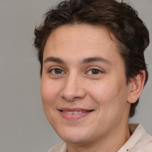 Joyful white adult male with medium  brown hair and brown eyes