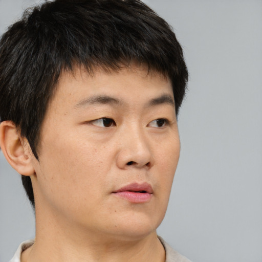 Neutral asian young-adult male with short  brown hair and brown eyes