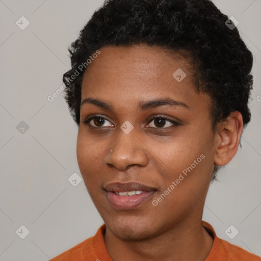 Joyful black young-adult female with short  black hair and brown eyes